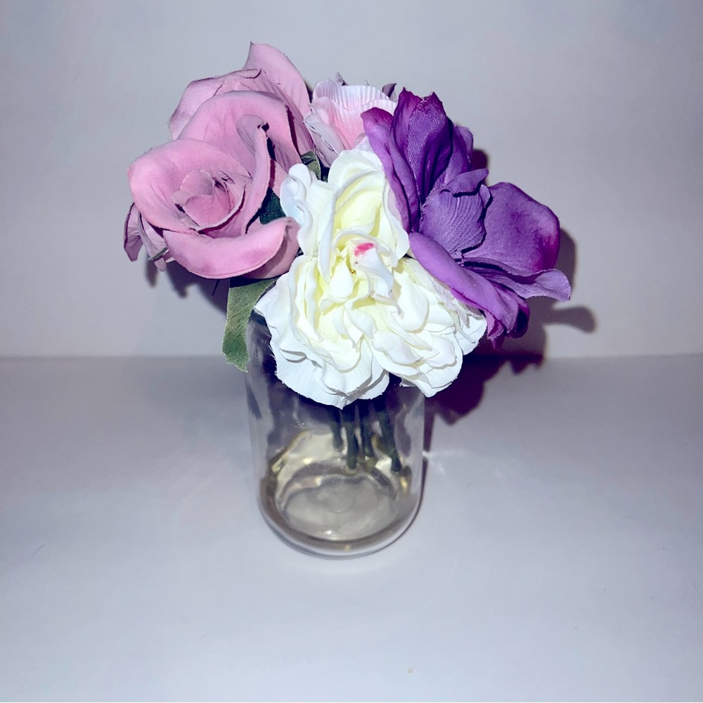 Faux floral arrangement in glass vase